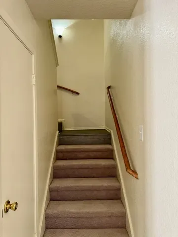 a view of a room with wooden floor a ceiling fan and window
