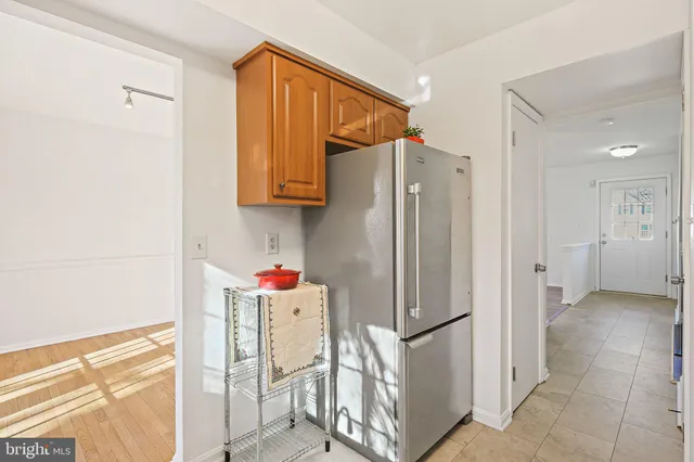 a kitchen with stainless steel appliances a refrigerator and cabinets
