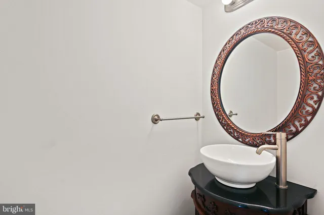 a bathroom with a toilet and a mirror