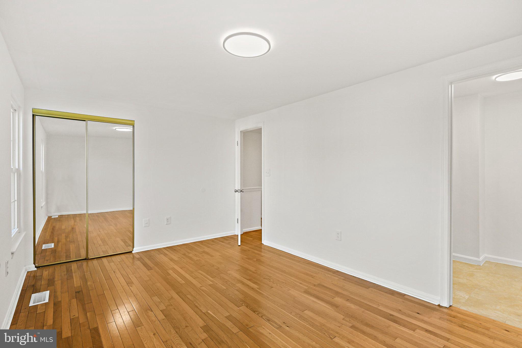 7510 Filbert Terrace Gaithersburg, MD 20879 - Photo 17 of 40 an empty room with wooden floor and windows