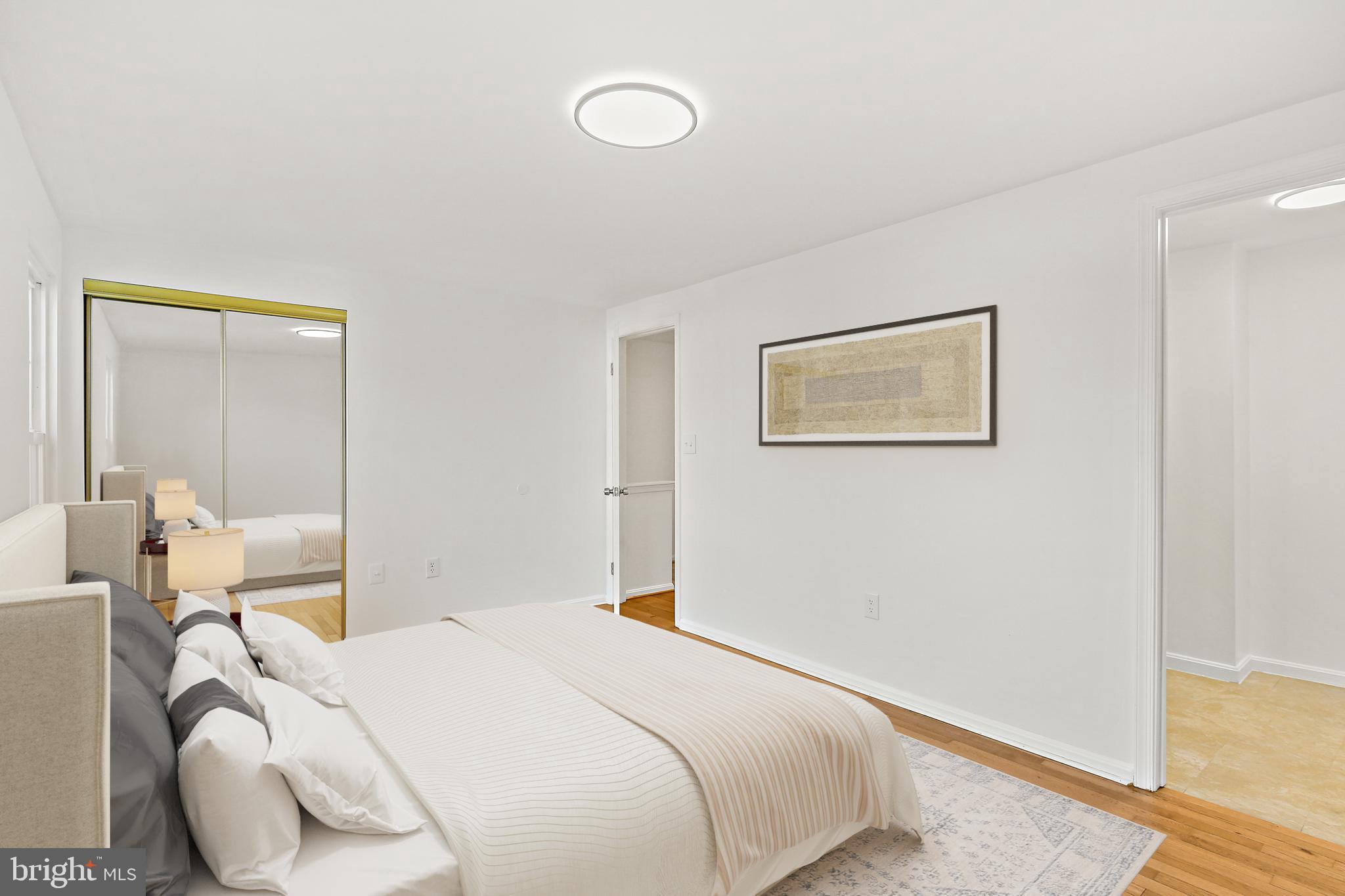 7510 Filbert Terrace Gaithersburg, MD 20879 - Photo 18 of 40 a bedroom with a bed and wooden floor