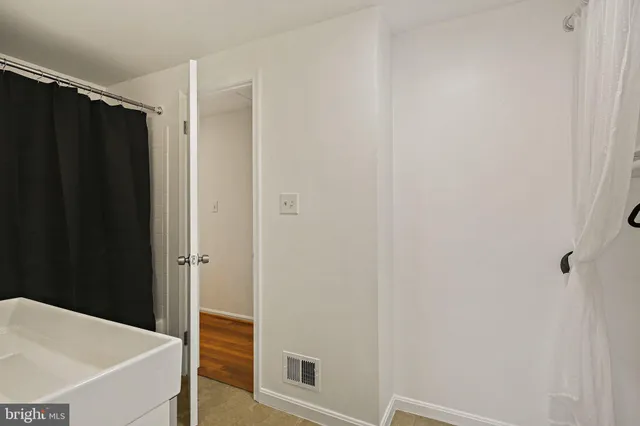 a bathroom with a shower and a sink