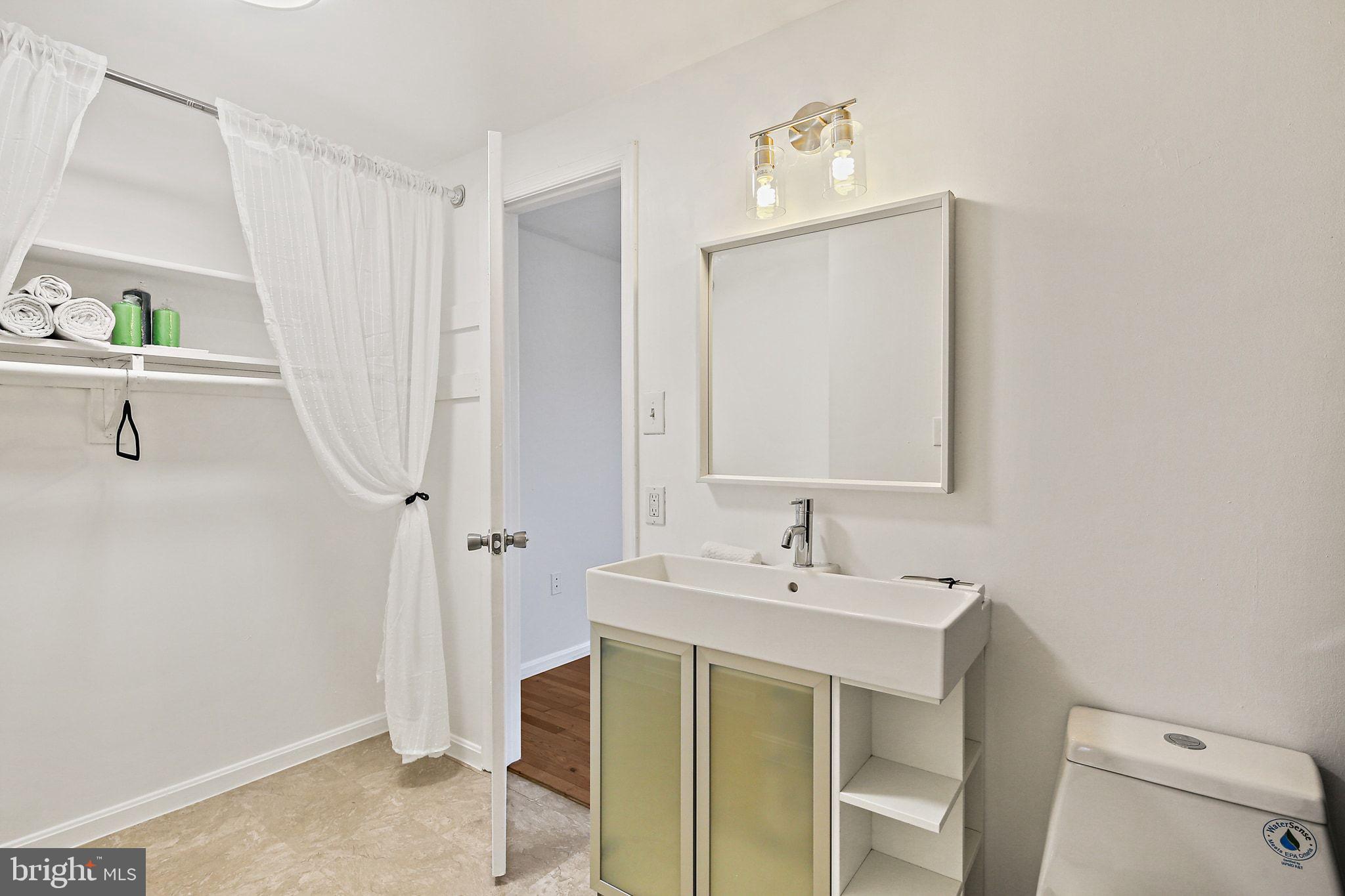 7510 Filbert Terrace Gaithersburg, MD 20879 - Photo 22 of 40 a bathroom with a sink vanity and a mirror