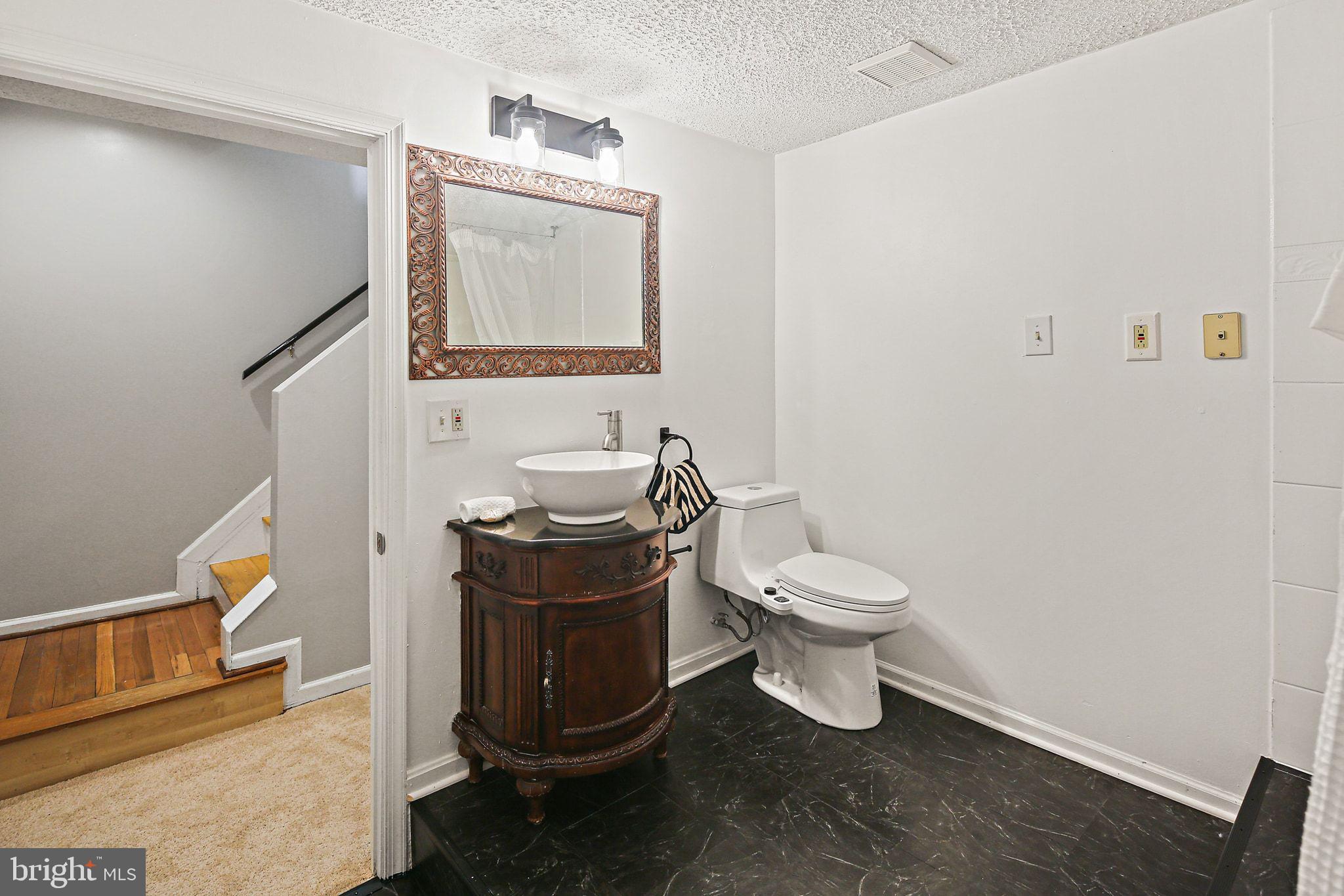 7510 Filbert Terrace Gaithersburg, MD 20879 - Photo 30 of 40 a bathroom with a toilet a sink and mirror