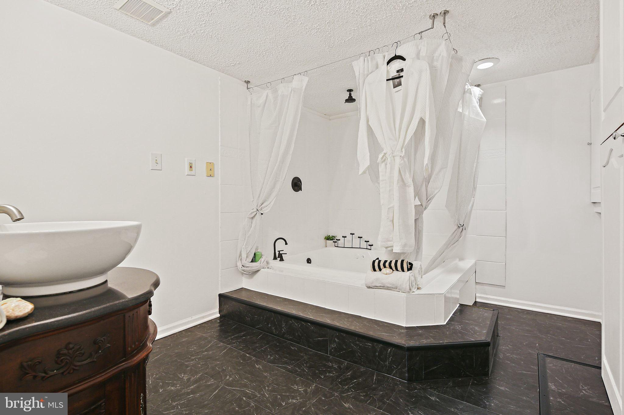 7510 Filbert Terrace Gaithersburg, MD 20879 - Photo 31 of 40 a bathroom with a sink and a mirror