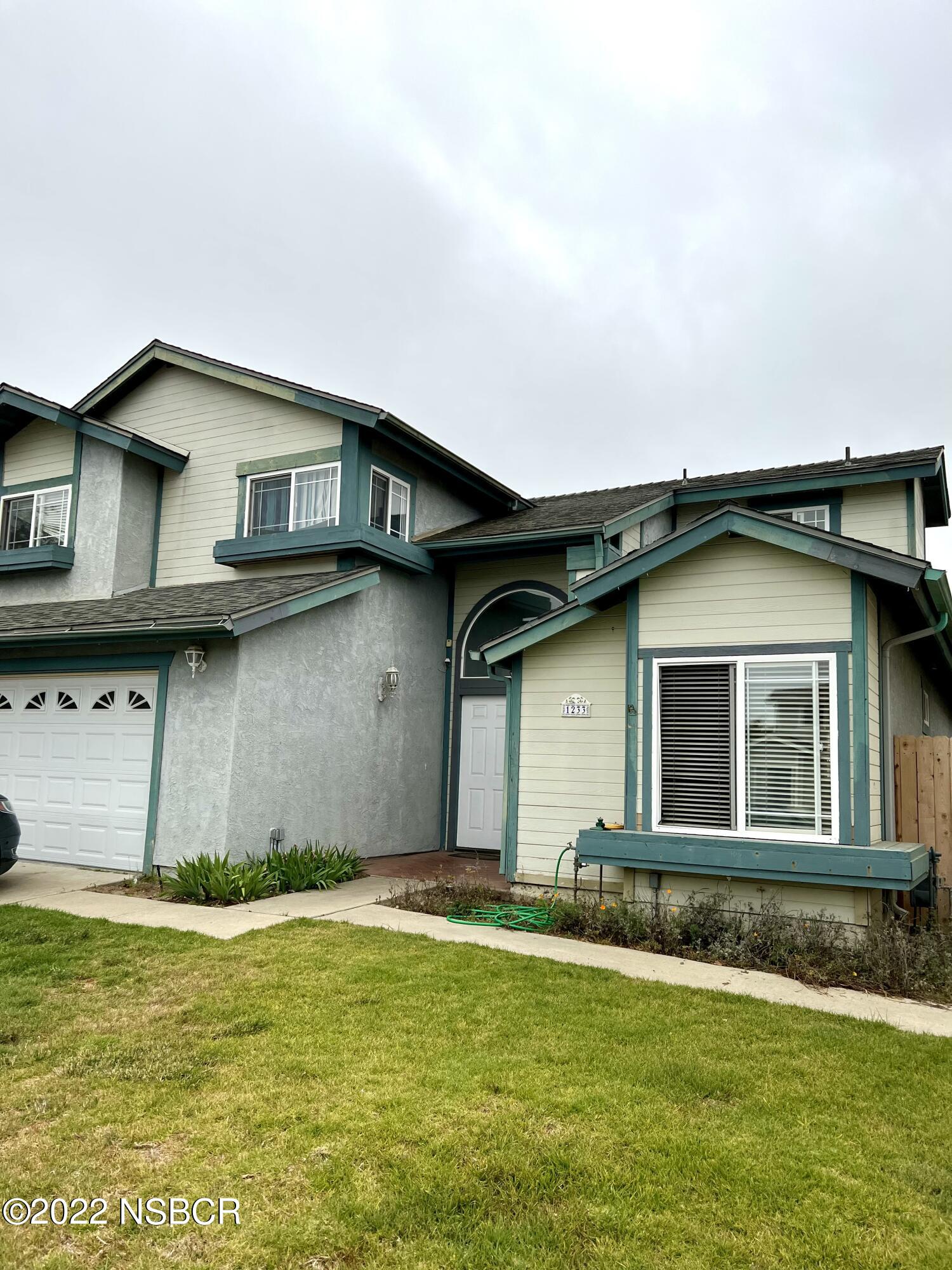 1233 Aster Lane Lompoc, CA 93436 - Photo 1 of 15 a house that has a big yard with wooden fence