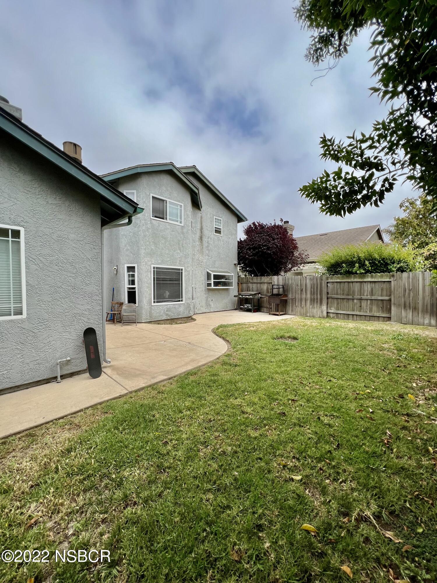 1233 Aster Lane Lompoc, CA 93436 - Photo 13 of 15 a backyard of a house with table and chairs