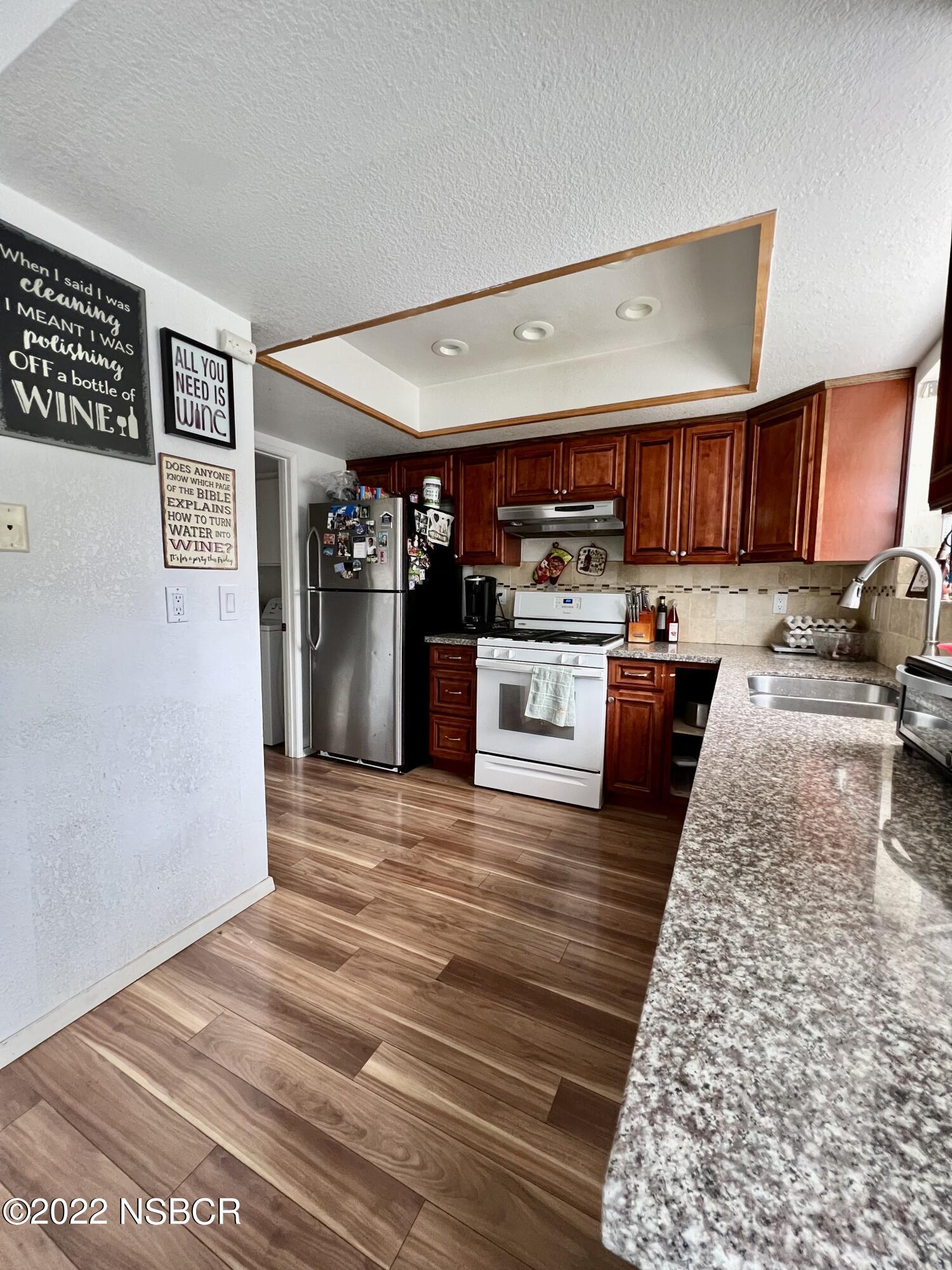1233 Aster Lane Lompoc, CA 93436 - Photo 3 of 15 a kitchen with stainless steel appliances granite countertop a refrigerator and stove