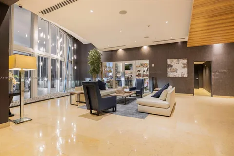 a living room with furniture pool table and a flat screen tv