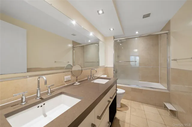 a bathroom with a sink double vanity and a shower