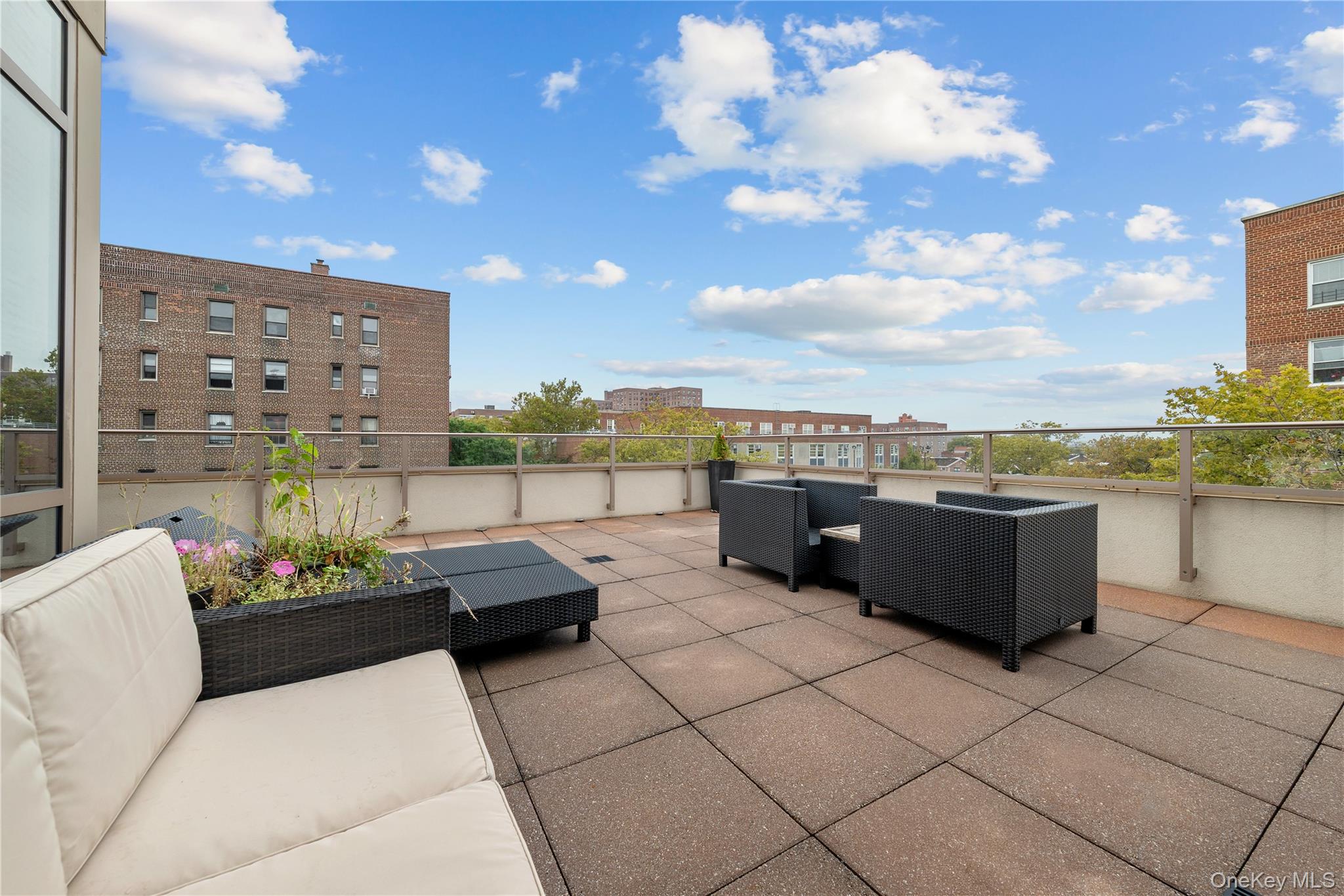 64-05 Yellowstone Boulevard, Unit PH 509 Queens, NY 11375 - Photo 19 of 28 a balcony with furniture and city view