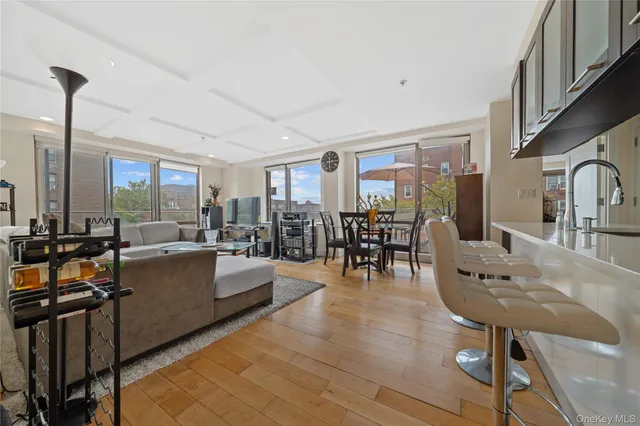 a living room with furniture a dining table and a large window