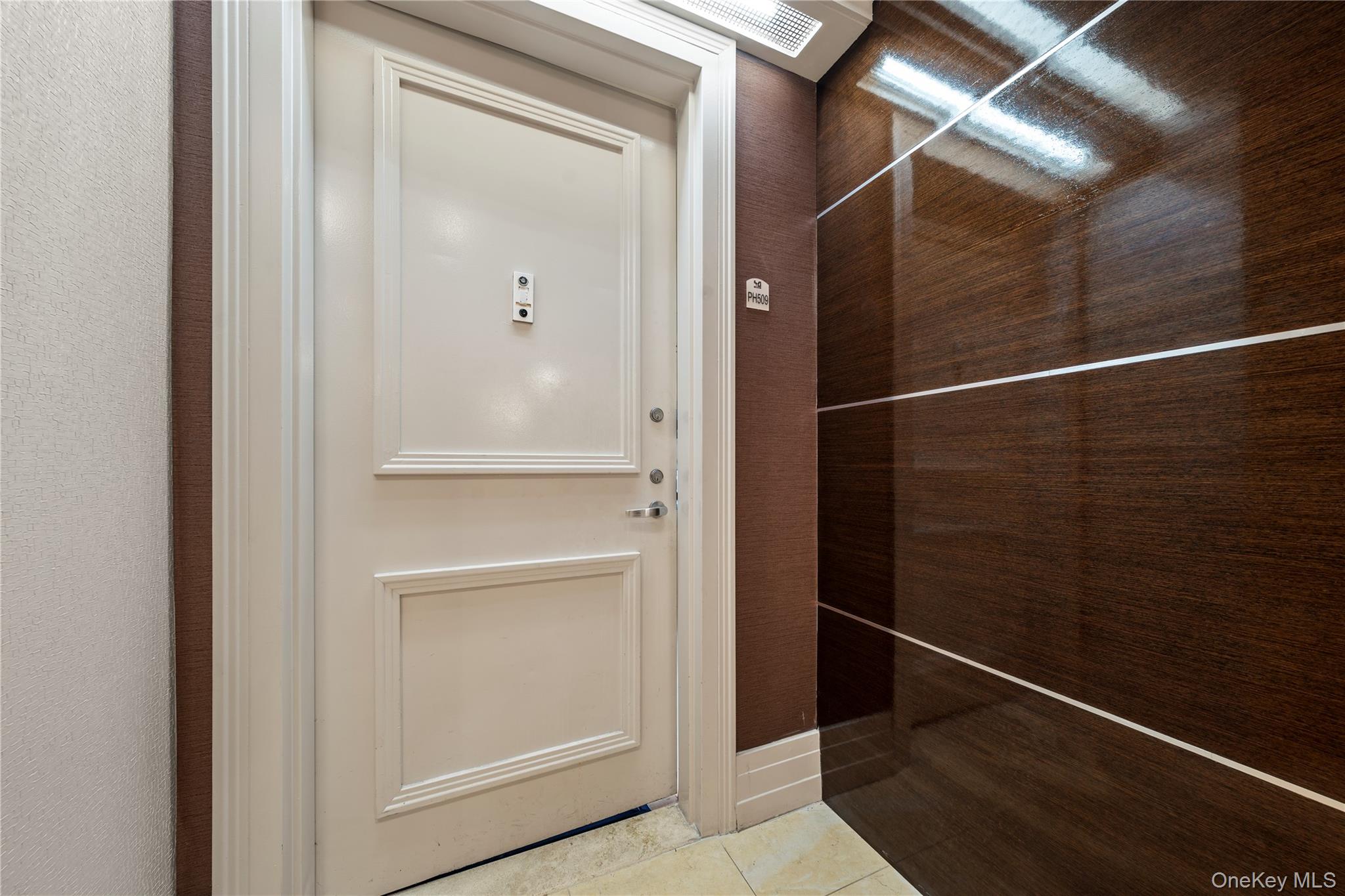 64-05 Yellowstone Boulevard, Unit PH 509 Queens, NY 11375 - Photo 27 of 28 a bathroom with a glass shower door