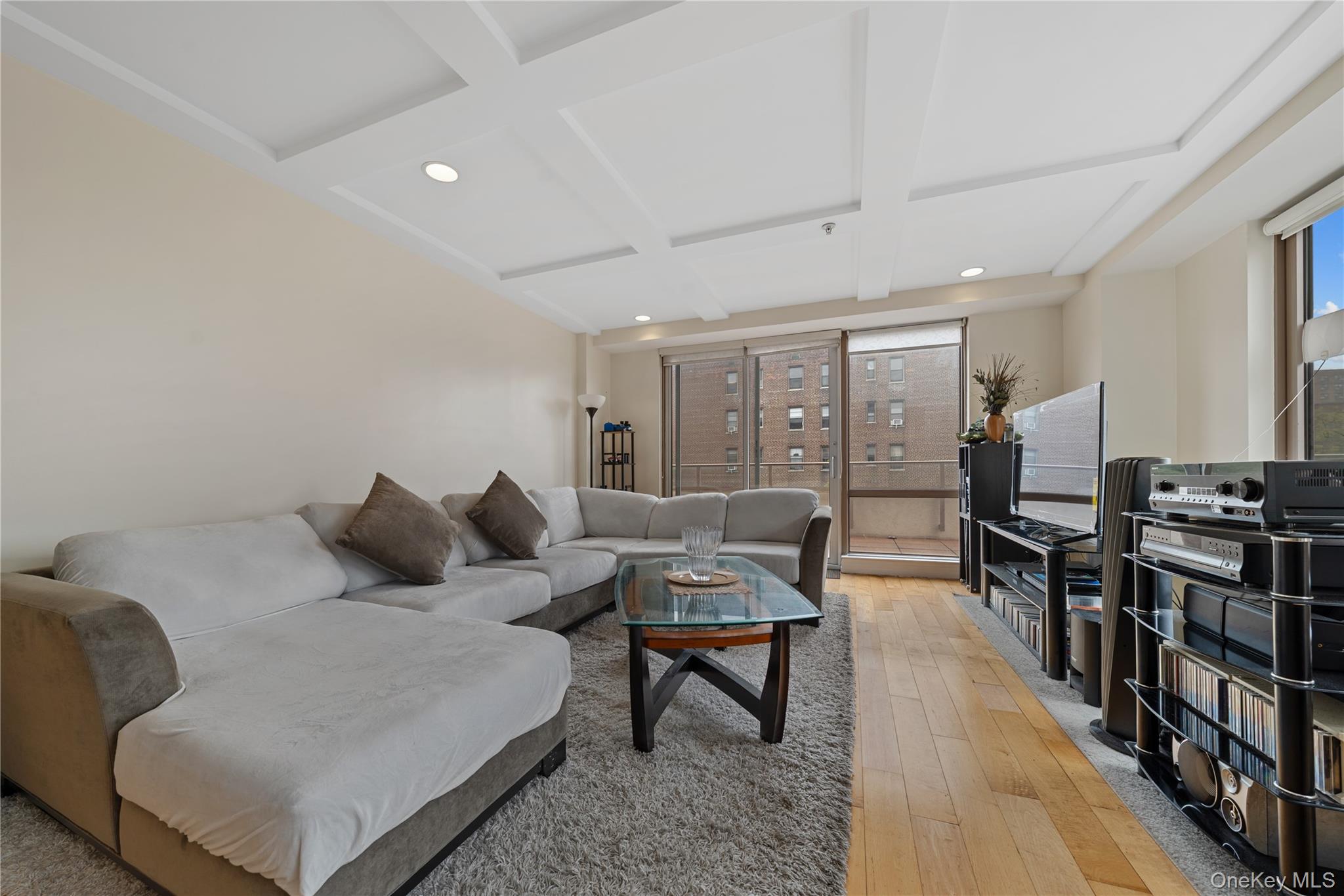 64-05 Yellowstone Boulevard, Unit PH 509 Queens, NY 11375 - Photo 3 of 28 a living room with furniture and wooden floor