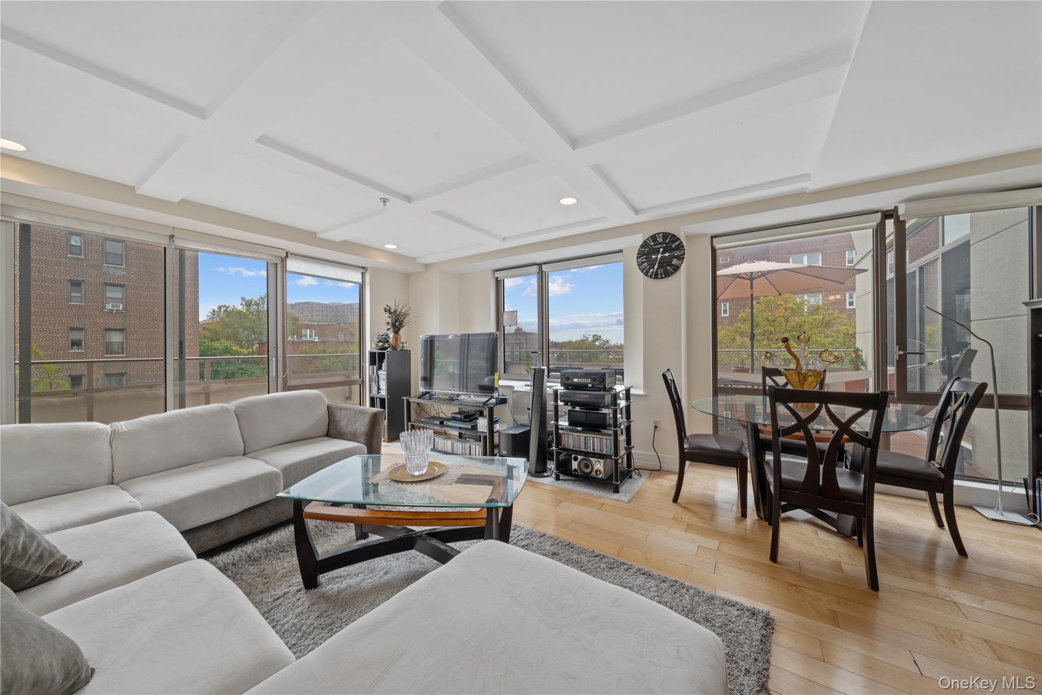 64-05 Yellowstone Boulevard, Unit PH 509 Queens, NY 11375 - Photo 4 of 28 a living room with furniture and a large window