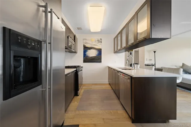 a kitchen with stainless steel appliances a sink and a refrigerator