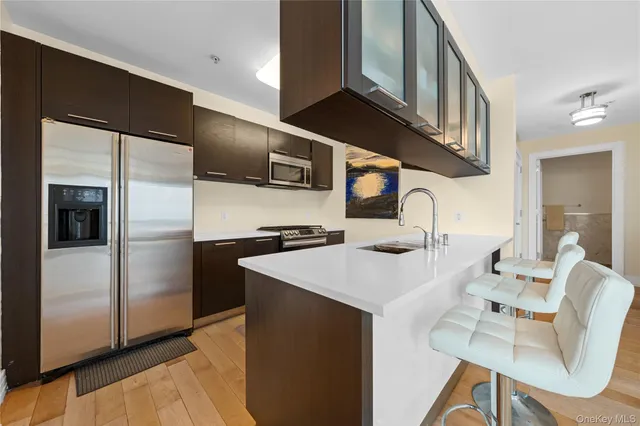 a kitchen with stainless steel appliances a sink and a refrigerator