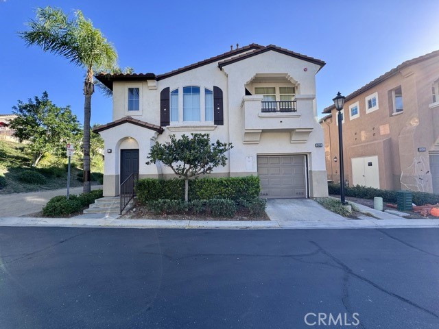 30455 Buccaneer Bay, Unit A Murrieta, CA 92563 - Photo 1 of 43 a front view of a house with a yard and garage