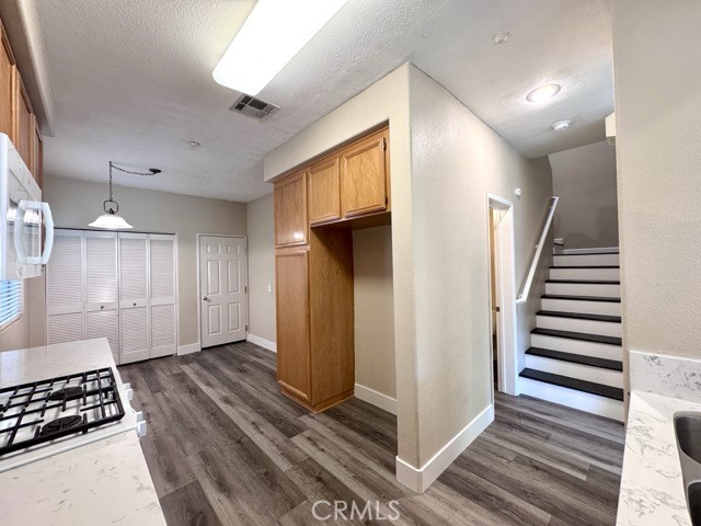 30455 Buccaneer Bay, Unit A Murrieta, CA 92563 - Photo 15 of 43 a view of a hallway with wooden floor and cabinets
