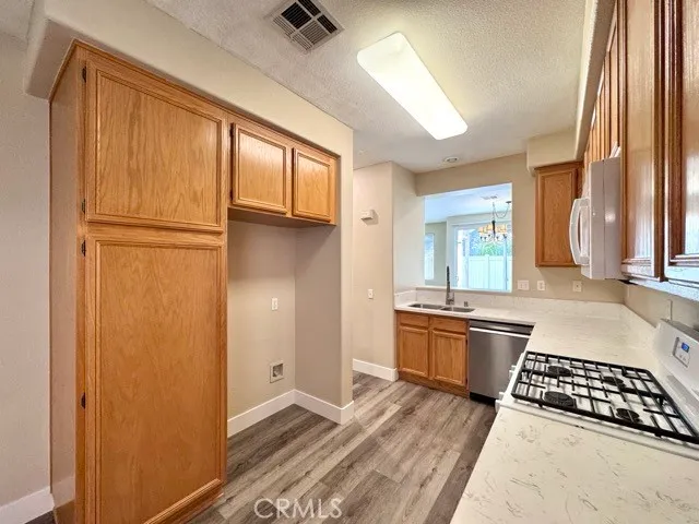 a kitchen with stainless steel appliances wooden cabinets and a stove top oven