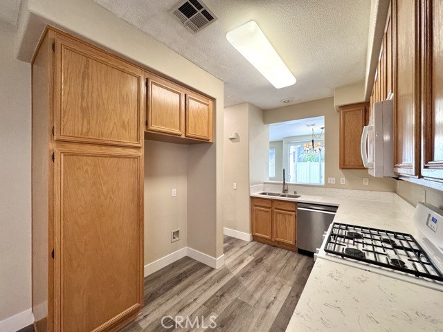 30455 Buccaneer Bay, Unit A Murrieta, CA 92563 - Photo 17 of 43 a kitchen with stainless steel appliances granite countertop a refrigerator and a stove top oven