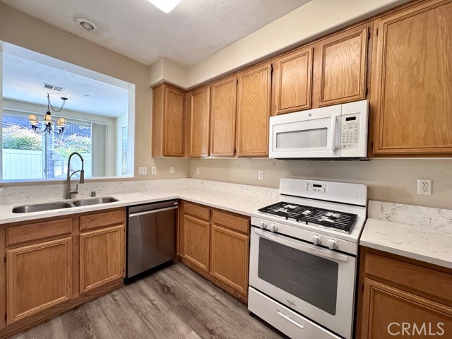30455 Buccaneer Bay, Unit A Murrieta, CA 92563 - Photo 18 of 43 a kitchen with stainless steel appliances wooden cabinets and a stove top oven