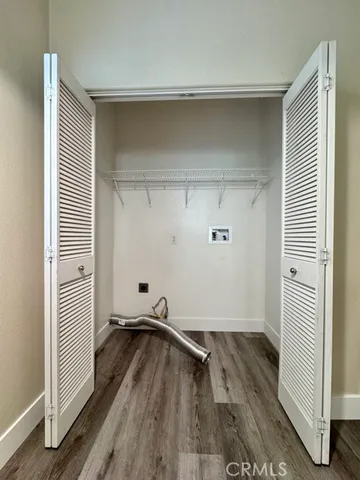 a view of entryway with furniture and wooden floor