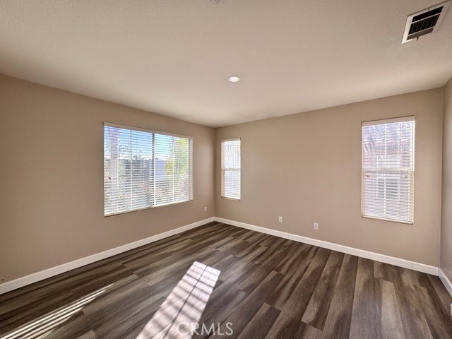 30455 Buccaneer Bay, Unit A Murrieta, CA 92563 - Photo 29 of 43 a view of an empty room with wooden floor and a window