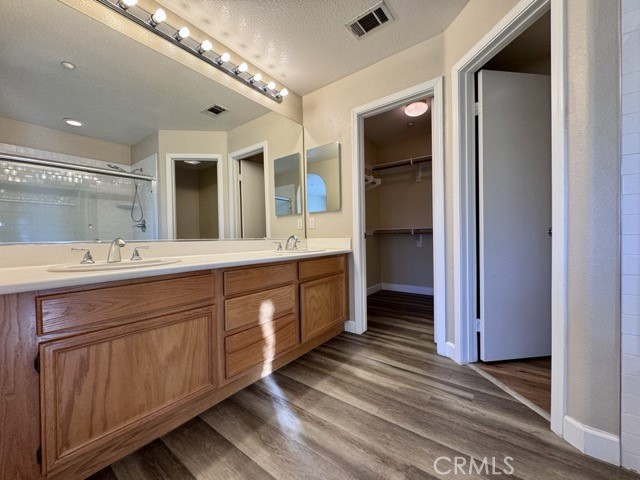 30455 Buccaneer Bay, Unit A Murrieta, CA 92563 - Photo 31 of 43 a spacious bathroom with a double vanity sink and a mirror