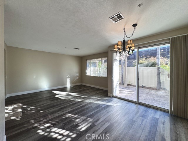 30455 Buccaneer Bay, Unit A Murrieta, CA 92563 - Photo 7 of 43 a view of an empty room with wooden floor and a window