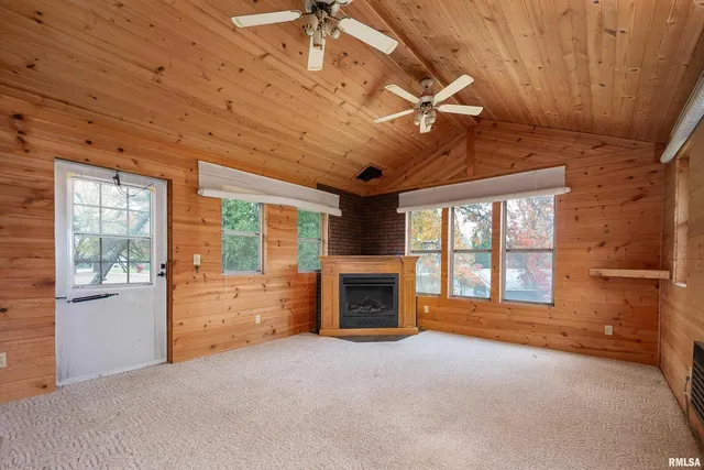 a big room with windows and fireplace