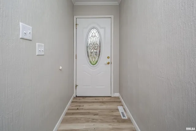 a view of a livingroom with wooden floor and a window