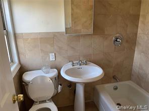 90 Murray Hill Street Elmont, NY 11003 - Photo 3 of 6 a bathroom with a sink toilet and shower