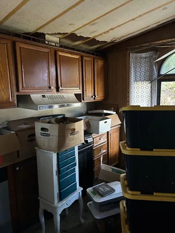 a kitchen with a stove a sink and a microwave