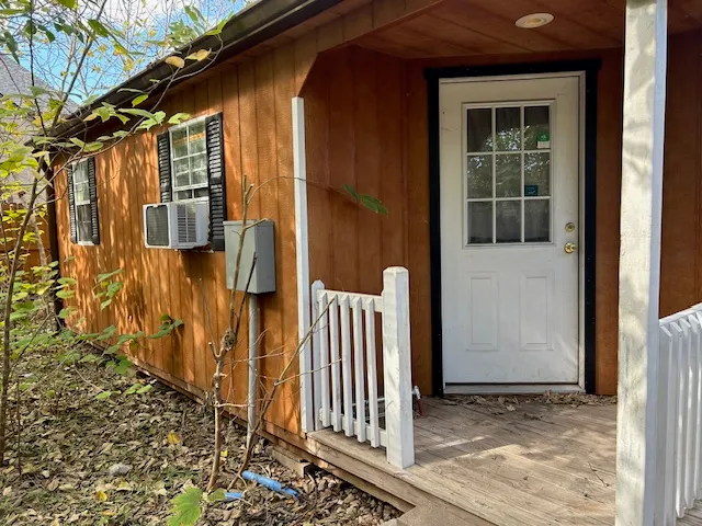 a view of a house with a wooden fence