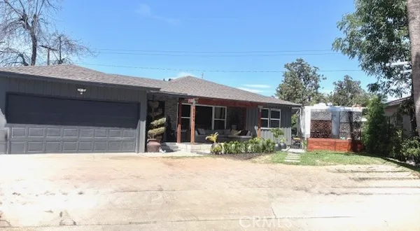 a front view of house with yard outdoor seating and barbeque oven