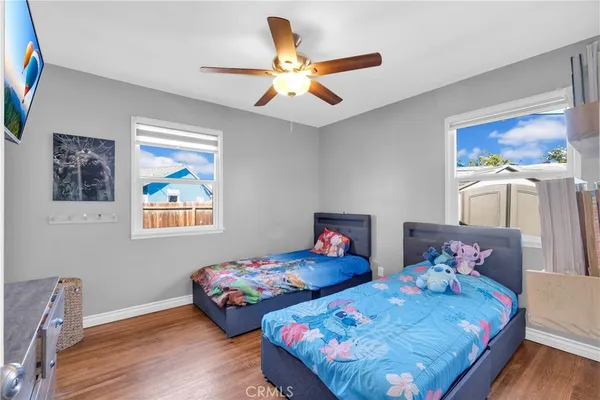 a bedroom with two beds and a chandelier