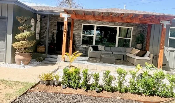 a view of a house with backyard porch and sitting area