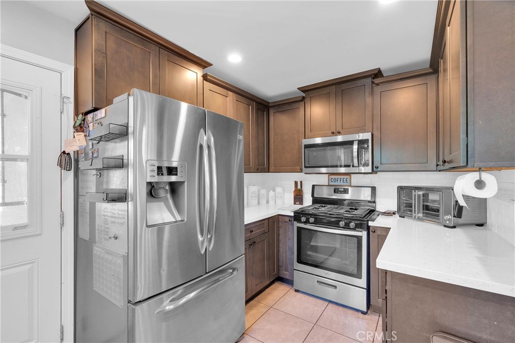 3595 Timothy Way Riverside, CA 92506 - Photo 9 of 19 a kitchen with stainless steel appliances a refrigerator stove and microwave