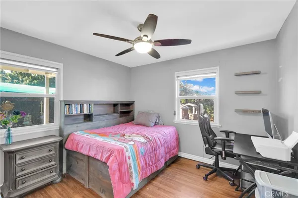 a bedroom with a bed and a desk