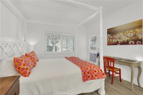 a bedroom with furniture and a flat screen tv