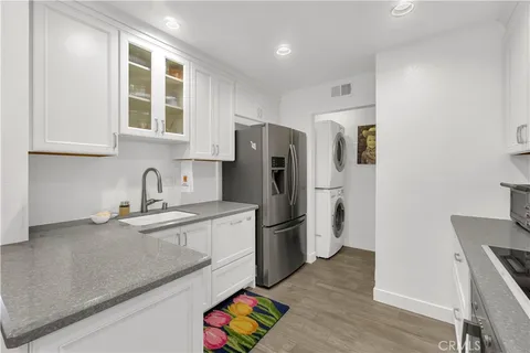 a kitchen with stainless steel appliances granite countertop a refrigerator and a sink
