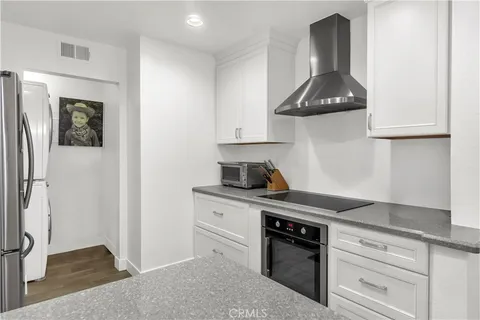 a kitchen with stainless steel appliances granite countertop a stove and a refrigerator