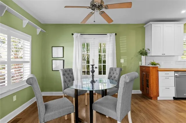 a view of a dining room with furniture window and wooden floor