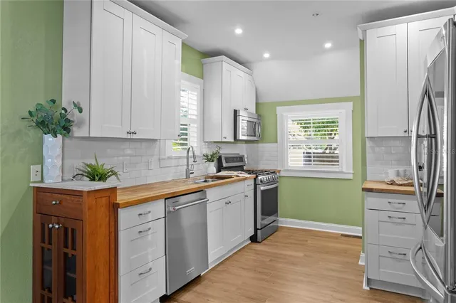 a kitchen with a sink stainless steel appliances and cabinets