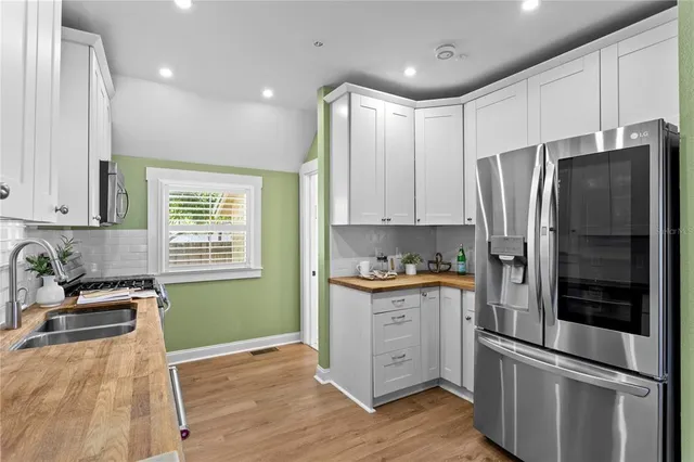 a kitchen with granite countertop stainless steel appliances and wooden cabinets
