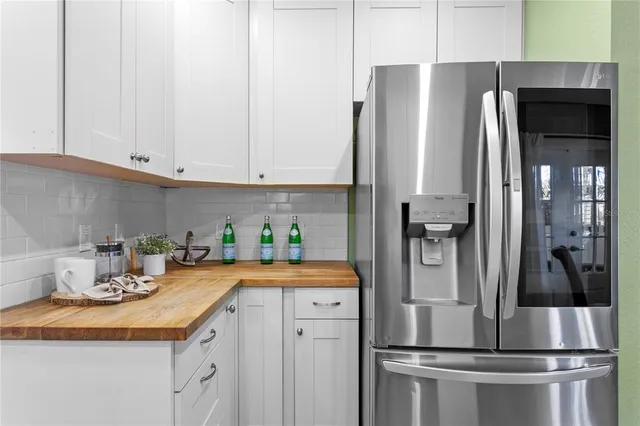 a kitchen with stainless steel appliances a refrigerator sink and cabinets