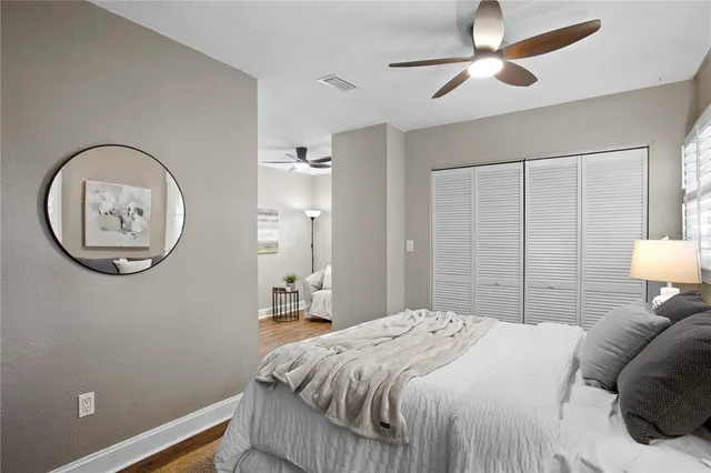 a bedroom with a bed and a chandelier