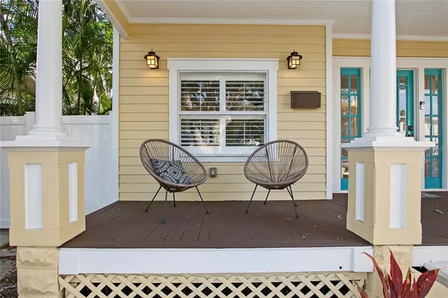 a view of balcony with two chairs and a potted plant