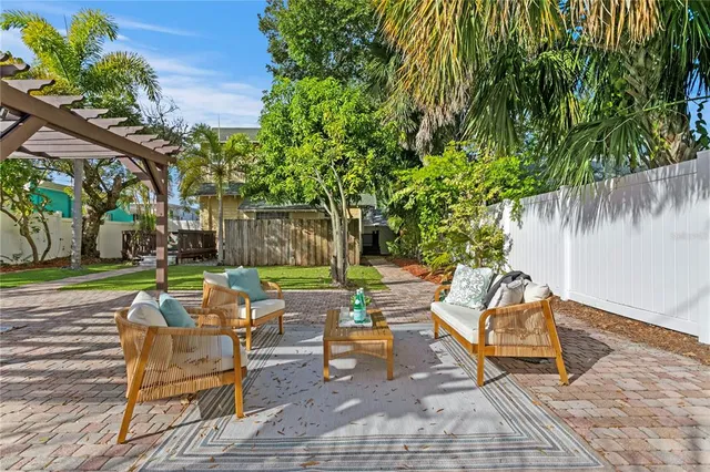 a backyard of a house with outdoor seating